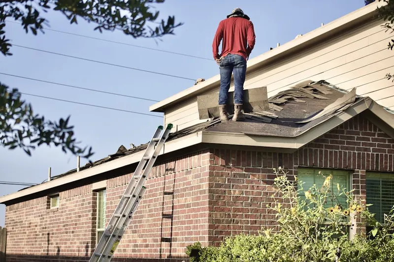 Professional roofer working on a residential roof in SoNo